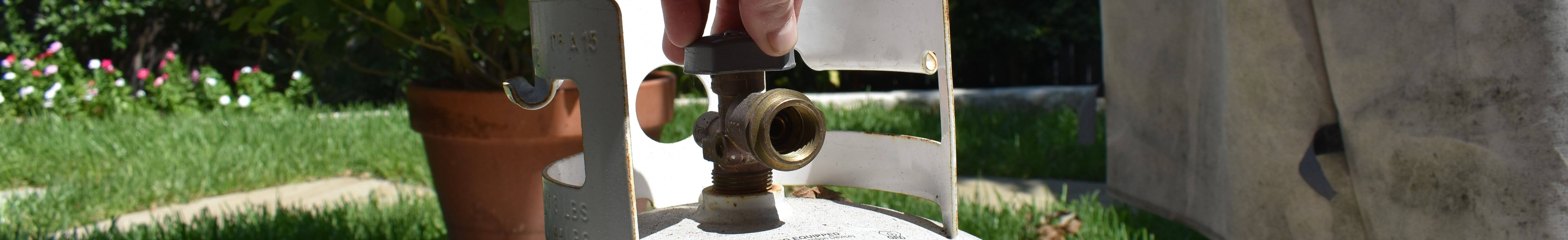 Opening a propane cylinder valve on a 20 lb bbq tank