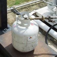 Five gallon propane cylinder being filled by weight