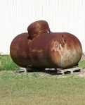 Rusted dark colored propane tank